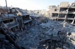 People are seen around destroyed buildings and debris at Dair El_Balah City, after an Israeli airstrikes that has been going on for Nine days in Gaza People are seen around destroyed buildings and debris at Dair El_Balah City, after an Israeli airstrikes