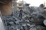 People are seen around destroyed buildings and debris at Dair El_Balah City, after an Israeli airstrikes that has been going on for Nine days in Gaza People are seen around destroyed buildings and debris at Dair El_Balah City, after an Israeli airstrikes