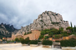 Santa Mar a de Montserrat in Monistrol, on a partly cloudy day in Catalonia, Spain with its characteristic rocks in the background.