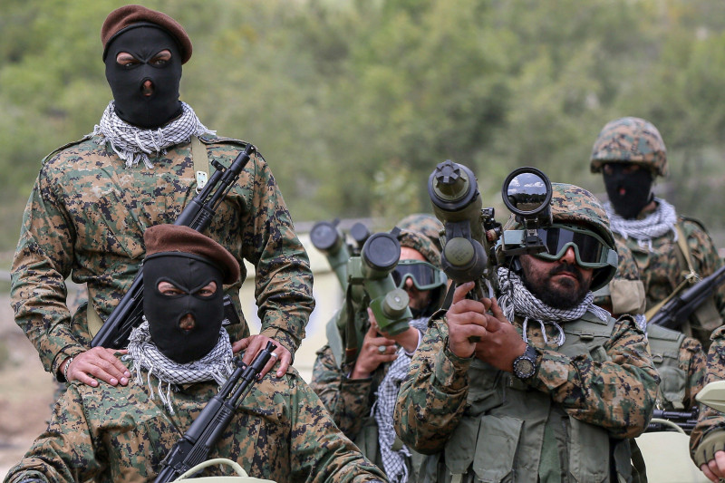 Aramta, Lebanon. 21st May, 2023. Pro-Iranian Hezbollah fighters take the oath during a staged military exercise in a camp in the Lebanese southern village of Aramta. The show came ahead of the 23rd "Liberation Day", the annual celebration of the withdrawa