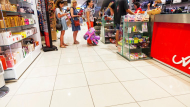 Queuing up to pay for goods in shop store Queue at till tills inside copy space copyspace