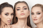 Three beautiful women with smokey make-up and wet hair studio portrait