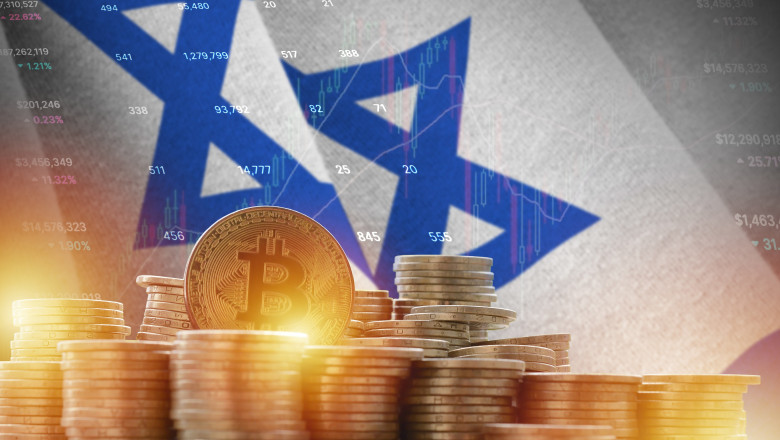Israel flag and big amount of golden bitcoin coins and trading platform chart. Crypto currency