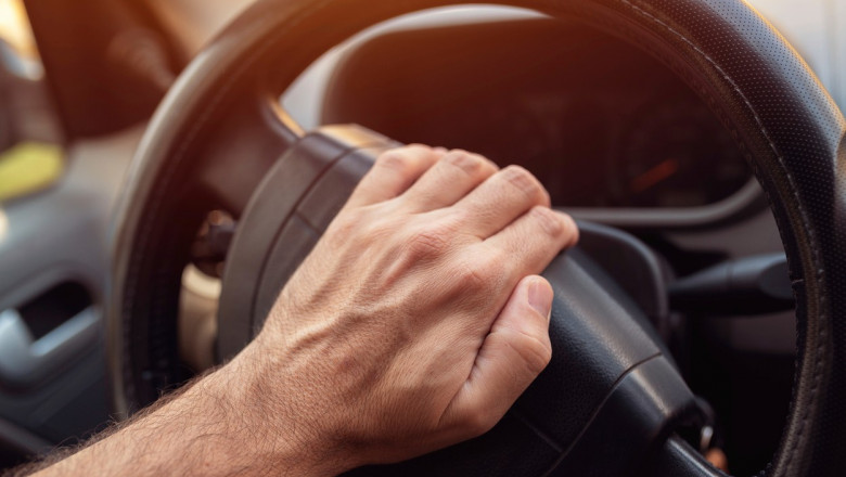 Driver pushing car horn