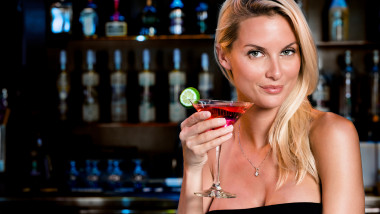 Woman drinking Cosmopolitan Martini at Bar
