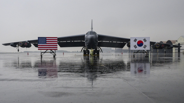 National flags of the US (L) and South Korea (R) are displayed in front of a B-52H strategic bomber parked at a South Korean Air Force base at Cheongju Airport