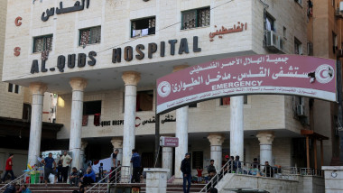 People wait outside Gaza City's Al-Quds Hospital on October 29