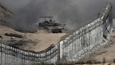 In this picture taken from the Israeli side of the border fence, an Israeli tank rolls inside the Gaza Strip on November 5, 2023