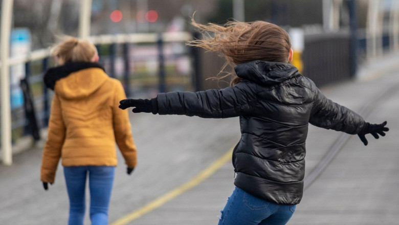 Southport, Merseyside, UK. 14th Dec, 2019. UK Weather; Strong winds at the coast for walkers on the pier at Southport. Credit: MediaWorldImages/Alamy Live News