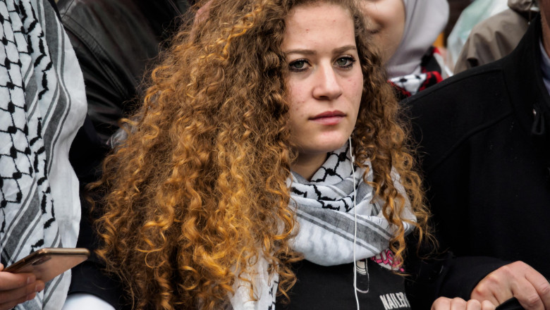 London, UK. 1th May 2019. Palestinian teenage activist Ahed Tamimi holds the banner at the front of the march from the BBC to a rally in Whitehall a few days before Nakba day showing solidarity with the Palestinian people and opposing continued Israel vio