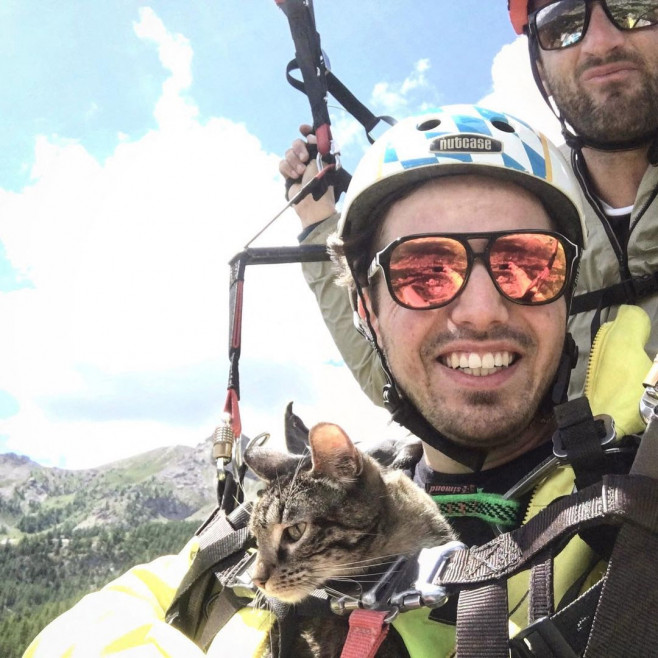 EXCLUSIVE: Man goes viral recreating famous scene from ET with his CAT – and they go paragliding and mountain climbing together too