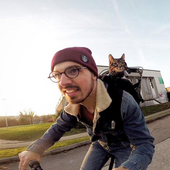 EXCLUSIVE: Man goes viral recreating famous scene from ET with his CAT – and they go paragliding and mountain climbing together too