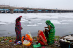 Hindu devotees perform rituals amid the polluted waters of the river Yamuna covered with a layer of toxic foam during the 10-day long Ganesh Chaturthi festival in New Delhi. The Ganesh Chaturthi is a Hindu festival to commemorate the birth of the Hindu go