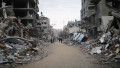 Palestinians walk among the rubble in the residential area Beit Lahia, north of the Gaza Strip Palestinians walk among t