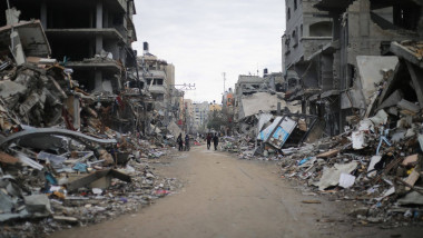Palestinians walk among the rubble in the residential area Beit Lahia, north of the Gaza Strip Palestinians walk among t