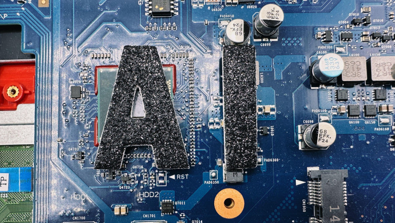 AI short for Artificial Intelligence in black lettering on a laptop computer motherboard to give a tech vibe