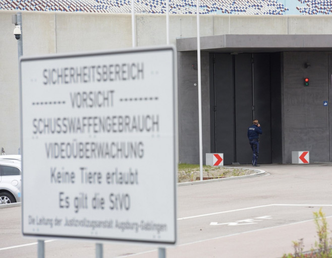 Gablingen, Germany. 30th Oct, 2018. A member of the judiciary makes a phone call at the gate of the Augsburg-Gablingen prison. The former Audi CEO Rupert Stadler was detained here on remand. Credit: Stefan Puchner/dpa/Alamy Live News