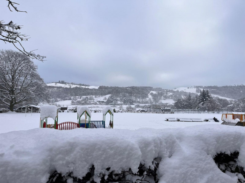 A family were forced to sleep the night in a school with his kids and 100 other motorists after heavy snow forced them to abandon their vehicles.