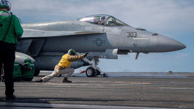U.S. Navy Lt. Andrew Bentley signals a F/A-18E Super Hornet to launch from USS Theodore Roosevelt on Nov. 30, 2023. Photo by Adina Phebus