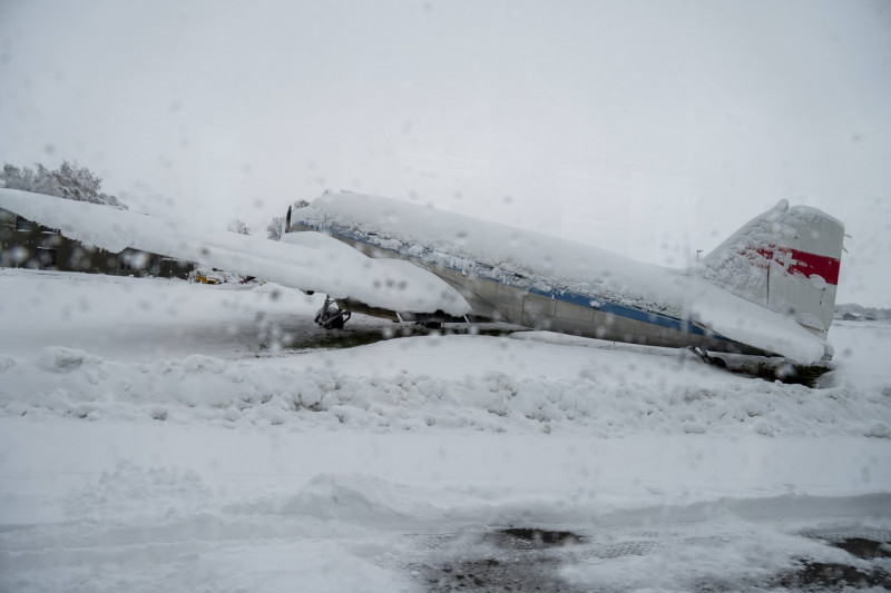 FMM, Bavaria, Germany - December 2, 2023: Onset of winter and snow chaos at the airport in Bavaria, A snowed-in airplane
