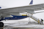 FMM, Bavaria, Germany - December 2, 2023: Onset of winter and snow chaos at the airport in Bavaria, Ryanair aircraft ful
