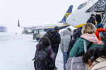 FMM, Bavaria, Germany - December 2, 2023: Onset of winter and snow chaos at the airport in Bavaria, passengers board a R
