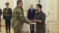 Russian propaganda caught faking a video by Ukrainian war commander General Valerii Zaluzhnyi staging a coup against Volodymyr Zelensky. Pictured: Zelensky awarding Zaluzhnyi