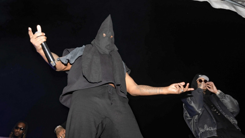 *EXCLUSIVE* Kanye stirs controversy with a hooded klan-esque mask at his album release party