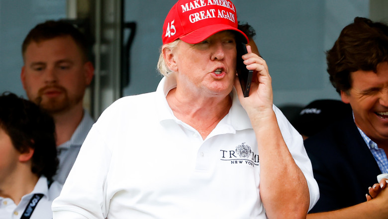 Former President Donald Trump on the phone, wearing red MAGA cap