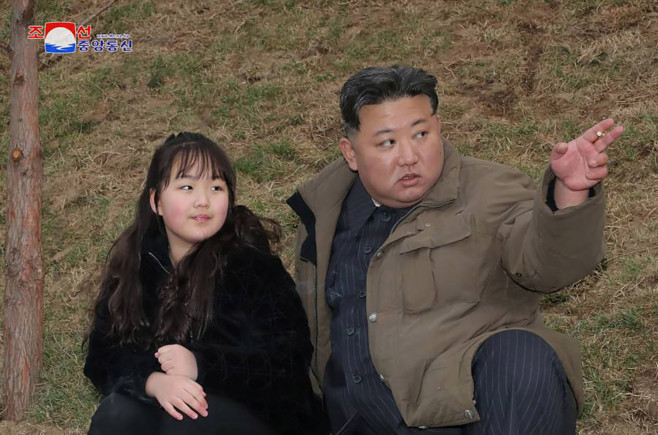 Kim Jong Un watches missile launch with wife and daughter