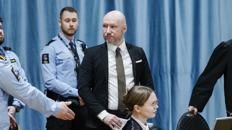 Anders Behring Breivik arrives at the courtroom in Ringerike prison surrounded by guards