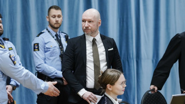 Anders Behring Breivik arrives at the courtroom in Ringerike prison surrounded by guards