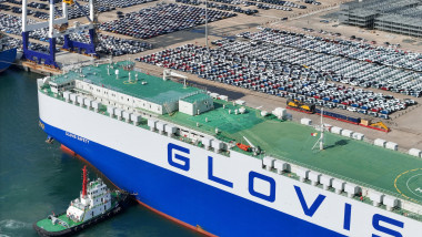 China: Tugboats push two Glovis RO-RO ships to a dockyard to transport new cars in a port in Yantai