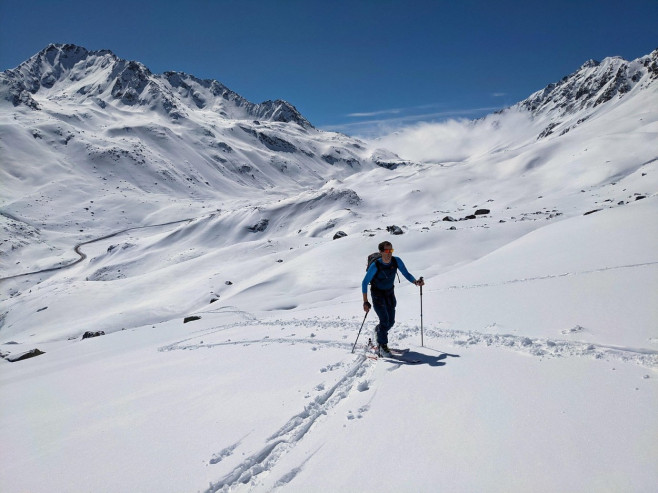 young man on a ski tour while ascending the mountain top.ski mountaineering in a wonderful mountain world in davos swiss