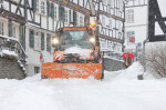 Starker Schneefall. Winter im Siegerland. Die Altstadt von Freudenberg ist eingeschneit. Ein Raeumfahrzeug (Räumfahrzeug