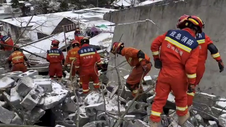 rescuers working at the site of a landslide in Liangshui Village, Tangfang Town in the city of Zhaotong, southwest China's
