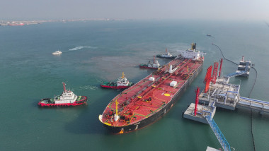 DONGYING, CHINA - NOVEMBER 15: Tugboats push the crude oil tanker VESNA from Singapore to a reception terminal of Dongyi