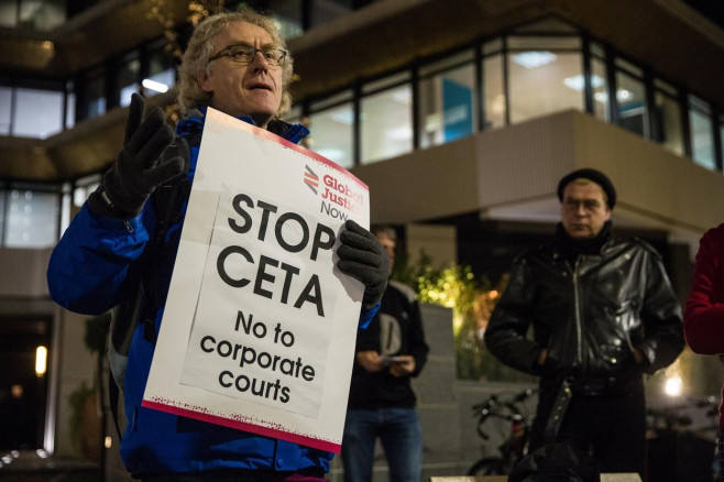 London, UK. 29th Nov, 2016. Campaigners from Global Justice Now protest outside the offices of RM Gold (Services) Ltd against CETA. In so doing, they were drawing attention to a current legal action by Gabriel Resources, a Canadian mining company, against