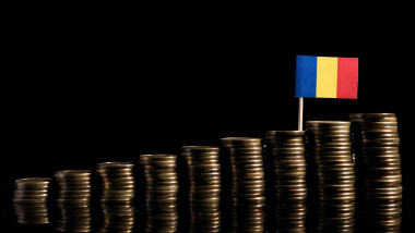 Romanian flag with lot of coins isolated on black background