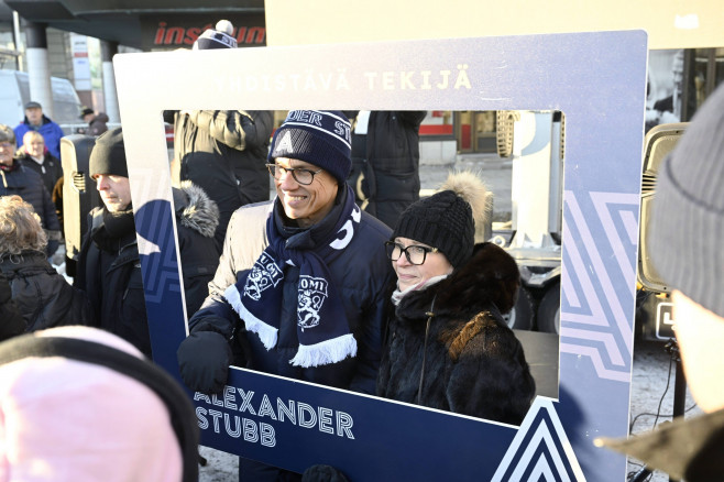 National Coalition Party (NCP) presidential candidate Alexander Stubb poses for a picture with supporters as he campaign