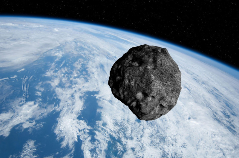 Planet Earth and big asteroid in the space. Blue Earth and asteroid. Space background. Elements of this image furnished by NASA.