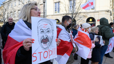 Belarusian Diaspora Rally Against Alexander Lukashenko In Warsaw. A woman holds a poster depicting Belarusian president
