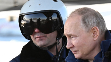 Vladimir Putin and a pilot look on before a test flight aboard a Tupolev Tu-160 M strategic missile carrier