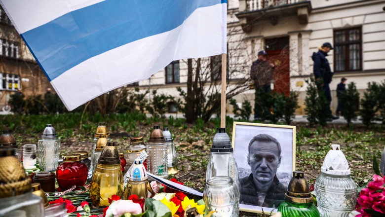 steagul opozanților pro-democrație din Rusia, alături de portretul lui Navalnîi, flori și candele