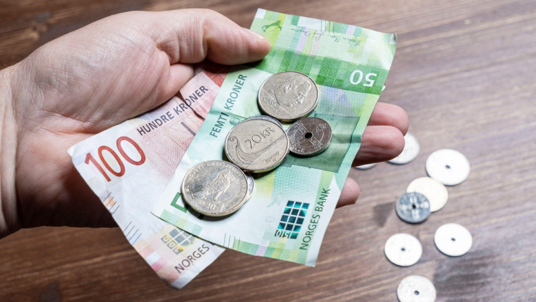 Oslo, Norway. September 2021. some Norwegian kroner bills and coins in the hand