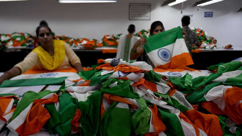 NOIDA, INDIA - AUGUST 8: Artisans making Indian tricolor in a factory in Noida Sector 6. Garment factories in Gautam Bud