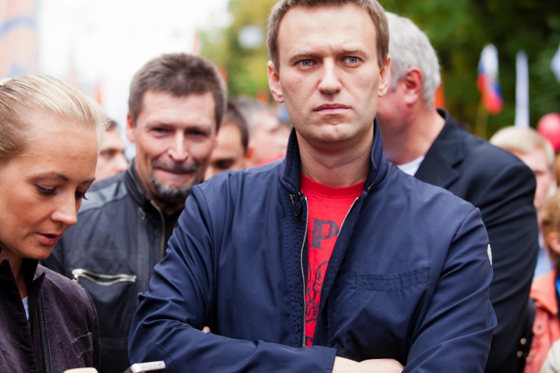 Russian opposition leader Alexei Navalny (right) and his wife Yulia (left) attend an opposition march through a street in Moscow