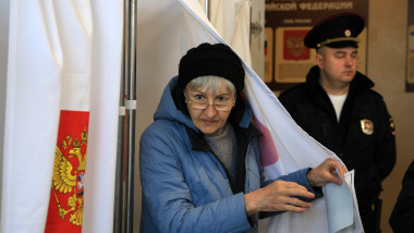 A woman votes in Russia's presidential election in Simferopol, Crimea