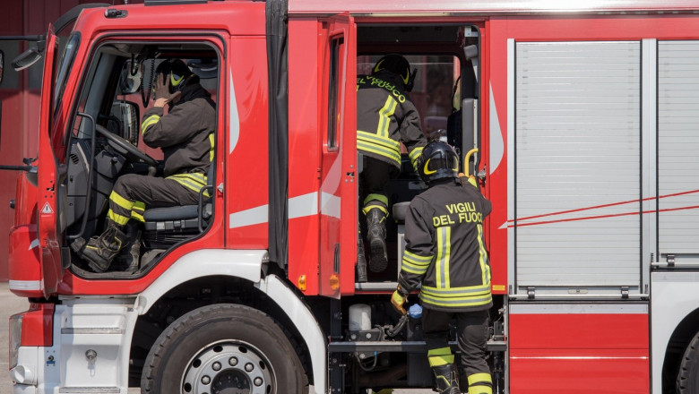 fast Italian firefighters climb on firetrucks during an emergency