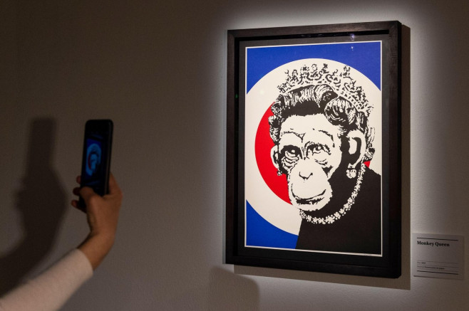 London, UK. 18 May 2021. A visitor views "Monkey Queen", 2003, by Banksy. Preview of The Art of Banksy at Seven Dials, Covent Garden. Over 100 pieces of Banksys works are on display from private collections across the globe and it is the first time the w
